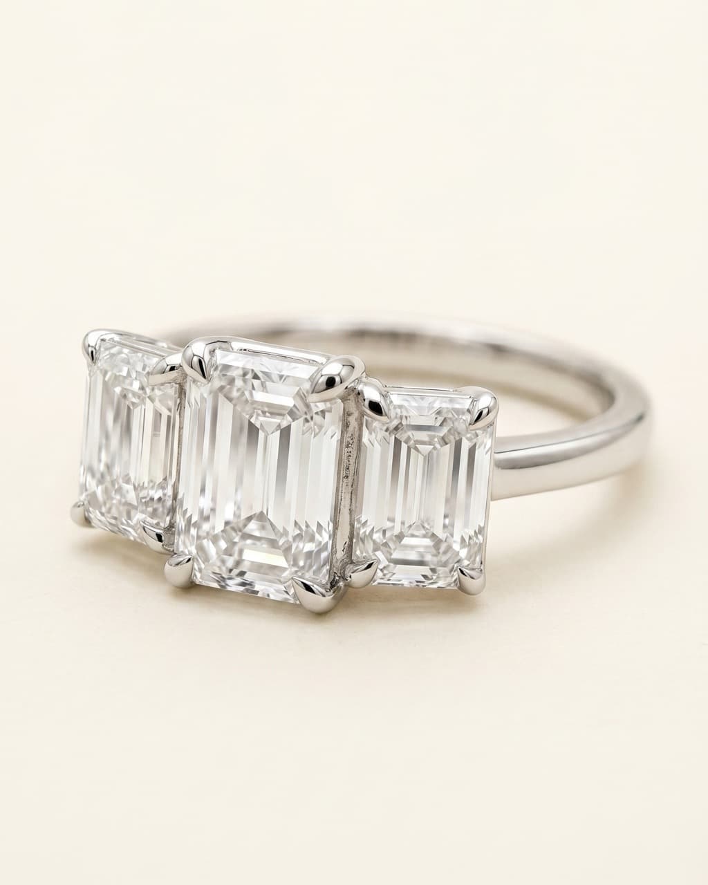 Emerald cut trilogy engagement ring in white gold